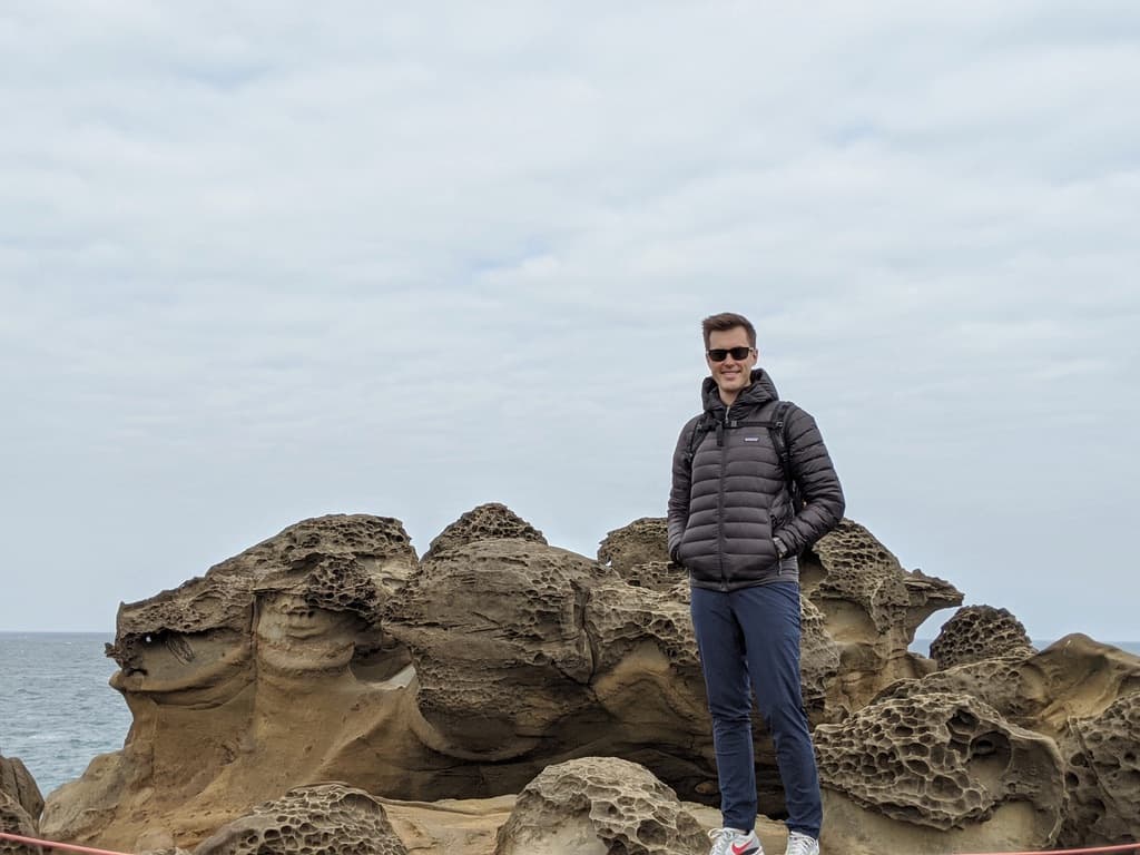 Tom Langridge standing on coastal rocks